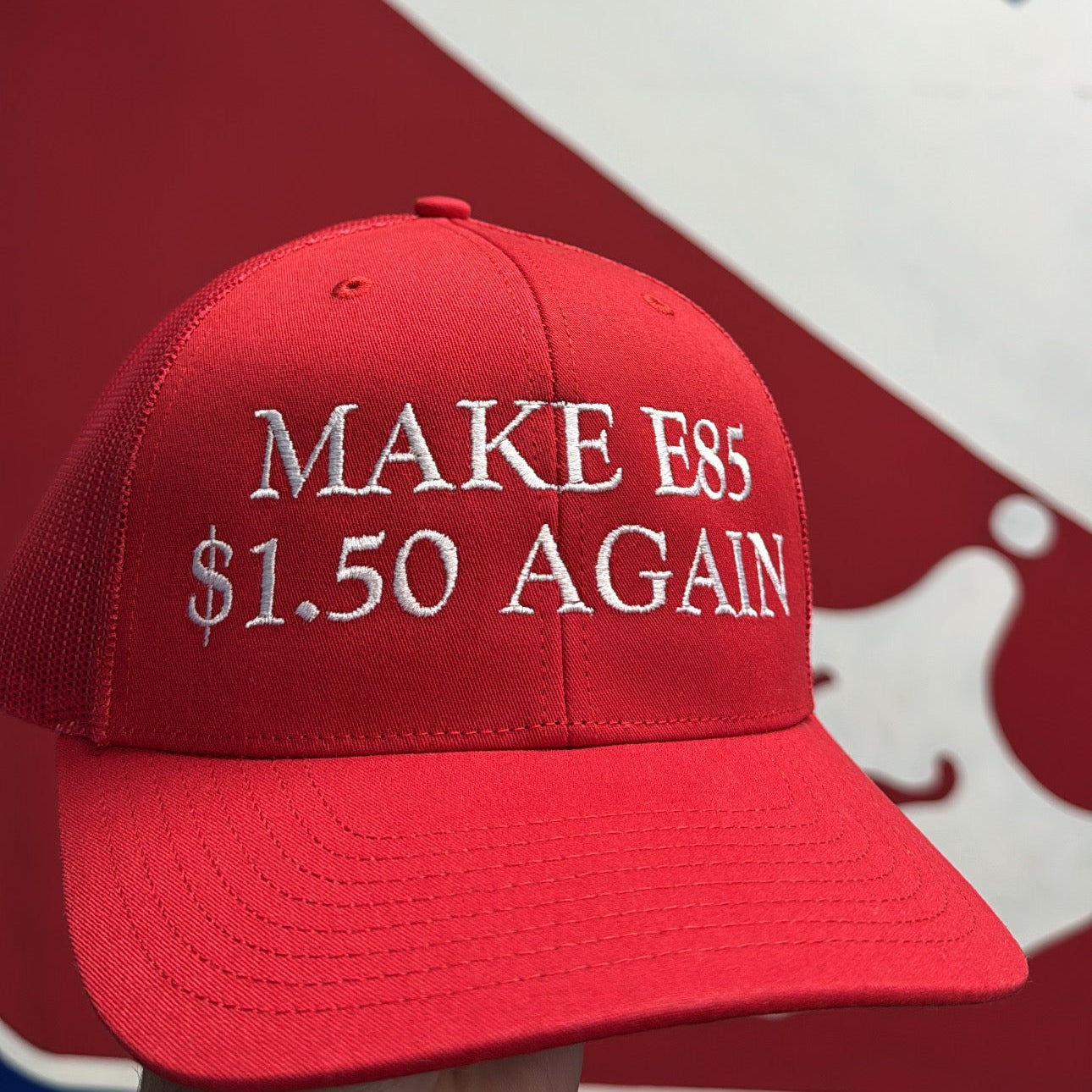 Red cap with 'MAKE ESS $1.50 AGAIN' text against a red, white, and blue background